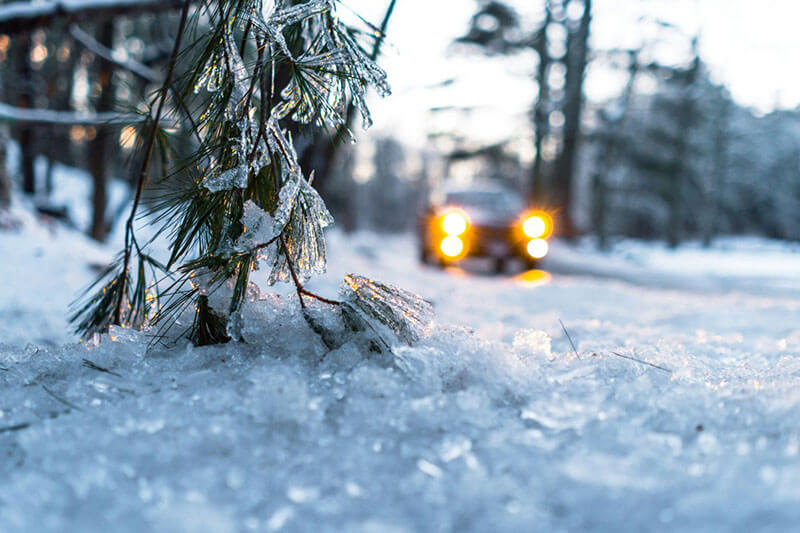 car on snow during daytime driving to fix emergency frozen pipe repar