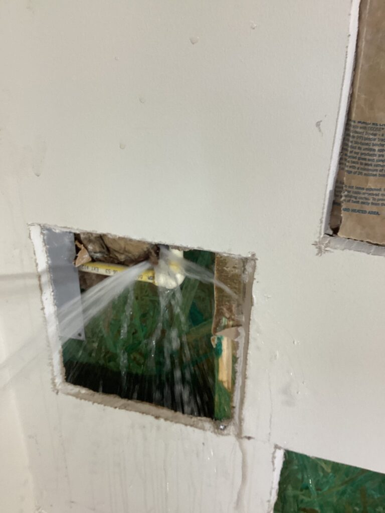 A frozen burst pipe leaking into the home